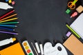 School supplies on black board background. Back to school concept. Frame, flatlay, copy space for text. Royalty Free Stock Photo