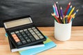 School supplies on black board background. Color pencils, calculator, rules and copybooks. Back to school concept. 1of September Royalty Free Stock Photo