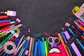 School supplies on black board background with copy space. Back to school Royalty Free Stock Photo