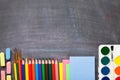 School supplies on blackboard background Royalty Free Stock Photo