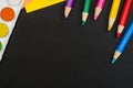 School supplies border on black chalkboard background. Top view photograph Royalty Free Stock Photo