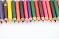 School supplies colored pencils in a row, isolated Royalty Free Stock Photo