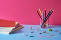 School supplies with colorful pencils and notebooks.