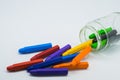 School supplies, colourful crayons stationery in clear jar on white background Royalty Free Stock Photo