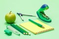School supplies. Compass, color pencils, notebook with pen, apple and stapler