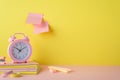 School supplies concept. Photo of alarm clock copybooks pens adhesive tape mini stapler eraser and sticky note paper attached to Royalty Free Stock Photo