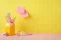 School supplies concept. Photo of pink and yellow stationery pencil holder adhesive tape mini stapler and sticky note paper Royalty Free Stock Photo