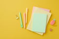 School supplies concept. Top view photo of colorful stationery stack of diaries pineapple shaped eraser binder clips and pens on