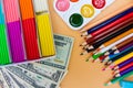 School supplies and dollars. Concept is to buy stationery objects. Royalty Free Stock Photo