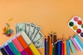 School supplies and dollars. Concept is to buy stationery objects. Royalty Free Stock Photo