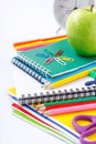 School supplies with green apple and alarm clock Royalty Free Stock Photo