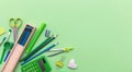 School supplies on green color background, top view, copy space Royalty Free Stock Photo