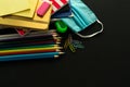 School supplies and medical mask, school opening, return to school after COVID-19 pandemic, new normal concept. Copy space. Royalty Free Stock Photo