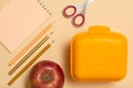 School supplies. Notebook, color pencils and lunch box Royalty Free Stock Photo