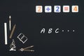 School supplies placed on black background with text ABC Royalty Free Stock Photo