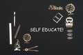 School supplies placed on black background with text self educate