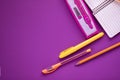 School supplies on purple background. Notebook open page. Royalty Free Stock Photo