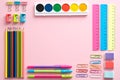School supplies set on pink background top view. Creative back to school flat lay