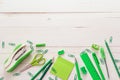 School supplies in shades of green on a background of white wood Royalty Free Stock Photo