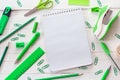 School supplies in shades of green on a background of white wood Royalty Free Stock Photo