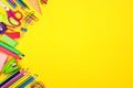 School supplies side border over a yellow background Royalty Free Stock Photo