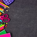 School supplies side border, top view on a chalkboard background with copy space. Back to school. Royalty Free Stock Photo