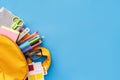 School supplies sticking out of a backpack on a blue background. Back to school concept Royalty Free Stock Photo