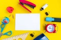 School supplies and white mockup blank on bright yellow background, top view. Royalty Free Stock Photo