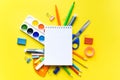 School supplies on a yellow background under a white notebook with copy space. Stationary, back to school,summer time, creativity Royalty Free Stock Photo
