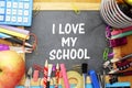 School supply on small blackboard with i love my school words