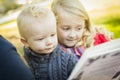 School Teacher Reading a Book to Two Adorable Blonde Children