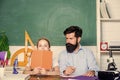 School teacher and schoolgirl. Man bearded teacher excellent pedagogue. Pedagogue skills. Talented pedagogue. Work