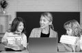 School teacher with a schoolkids learning at laptop computer, studying with online education. Teacher and little Royalty Free Stock Photo