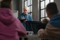 School teacher standing in front of pupils and writing notes in computer classroom at school Royalty Free Stock Photo