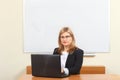 A school teacher teaches a lesson online against the background of a blackboard Royalty Free Stock Photo