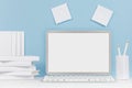 School template - white books, stationery, blank stickers and notebook computer on white desk and soft blue background.