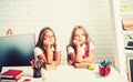 School time of girls. Back to school and home schooling. Little girls eat apple at lunch break. Friendship of small Royalty Free Stock Photo