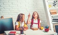 School time of girls. Friendship of small sisters in classroom at knowledge day. Little girls eat apple at lunch break Royalty Free Stock Photo