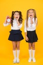 School time. Surprised shocked kids hold alarm clock counting time. Latecomer will be punished. It is time. School Royalty Free Stock Photo