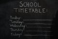 School timetable drawn on black chalkboard