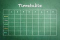 School timetable on green chalkboard background