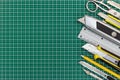 School tools and office supplies on green cutting mat background Royalty Free Stock Photo