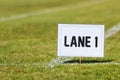 School track and field Lane 1 sign on grass