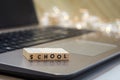 SCHOOL virtual learning concept with wood block letters on laptop Royalty Free Stock Photo