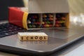 SCHOOL virtual learning concept with wood block letters on laptop Royalty Free Stock Photo