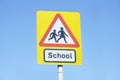 School warning sign blue sky red triangle road safety children young kids parent