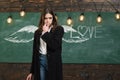 School wings and dream. School lessons. Young attractive teacher pointing at chalkboard. Back to school and happy time Royalty Free Stock Photo