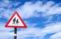 School zone or children crossing sign isolated on cloudy sky background Royalty Free Stock Photo