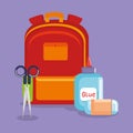 Schoolbag supply with sccisors and glue bottle Royalty Free Stock Photo