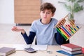 Schoolboy with abacus studying math at home